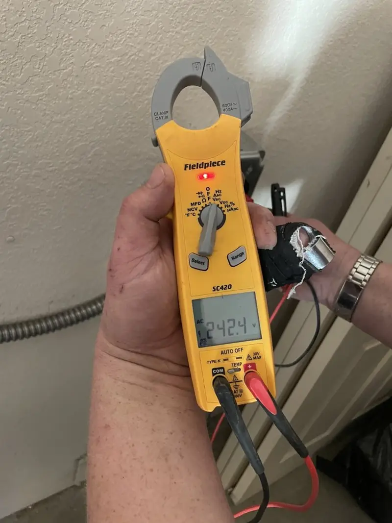 Voltage testing with clamp meter during Ceiling Fan Installation in West Goshen